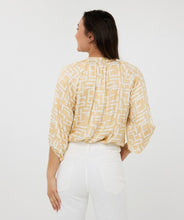 Load image into Gallery viewer, Brighten up your wardrobe with this lightweight shimmer blouse from EsQualo. The Eta Blouse features relaxed raglan three quarter sleeves, v-neckline, and a straight hem for an easy, untucked fit. Its soft, metallic sheen adds a touch of radiance, making it just as perfect for laid-back brunches as it is for polished workwear looks. Effortlessly stylish and breezy, it layers beautifully under blazers or shines on its own with denim and heels.
