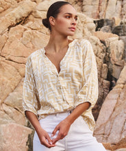Load image into Gallery viewer, Brighten up your wardrobe with this lightweight shimmer blouse from EsQualo. The Eta Blouse features relaxed raglan three quarter sleeves, v-neckline, and a straight hem for an easy, untucked fit. Its soft, metallic sheen adds a touch of radiance, making it just as perfect for laid-back brunches as it is for polished workwear looks. Effortlessly stylish and breezy, it layers beautifully under blazers or shines on its own with denim and heels.