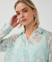 Load image into Gallery viewer, Woman wearing a light mint floral patterned sheer blouse against a white background.