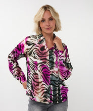 Load image into Gallery viewer, Woman wearing a colorful zebra print blouse and grey jeans against a white background.