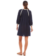 Load image into Gallery viewer, The Basilia Blouson Sleeve Embroidered Peasant Dress by Karen Kane is a beautifully crafted piece that blends boho-chic elegance with effortless comfort. Designed in a rich navy hue, this dress features intricate embroidery detailing and a tassel tie neckline, adding a charming touch to its relaxed silhouette. The blouson sleeves enhance its flowy appeal, making it perfect for seasonal transitions.
