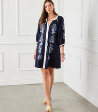 Load image into Gallery viewer, The Basilia Blouson Sleeve Embroidered Peasant Dress by Karen Kane is a beautifully crafted piece that blends boho-chic elegance with effortless comfort. Designed in a rich navy hue, this dress features intricate embroidery detailing and a tassel tie neckline, adding a charming touch to its relaxed silhouette. The blouson sleeves enhance its flowy appeal, making it perfect for seasonal transitions.