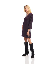 Load image into Gallery viewer, Woman wearing a dark purple and metallic dress and tall black boots against a white background.
