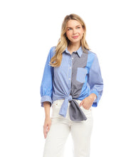 Load image into Gallery viewer, Woman wearing a blue, white and grey striped shirt standing against a white background.