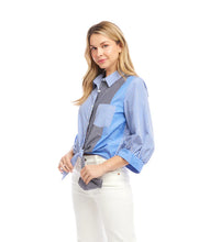Load image into Gallery viewer, Woman wearing a blue, white and grey striped shirt standing against a white background.