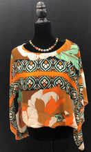 Load image into Gallery viewer, This gorgeous, flowy top showcases exquisite blouson sleeves for a touch of refinement and fashionable touch. Its relaxed fit allows for comfortable wear throughout the day, and the stunning multi print makes it a versatile piece to pair with black trousers or your favorite denim.