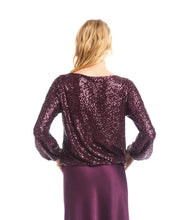 Load image into Gallery viewer, Woman wearing a purple sequin long sleeve blouse and purple silk skirt against a white background.