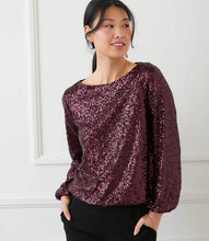 Load image into Gallery viewer, Woman wearing a sparkling purple long sleeve top and black pants against a white background.