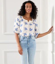Load image into Gallery viewer, Lightweight cotton gives a breezy quality to this peasant top detailed with charming floral embroidery. It's finished with statement-making puff sleeves. Colors- Off white and blue. Short sleeve. Button down. Floral embroidery.