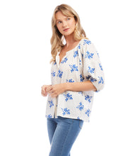 Load image into Gallery viewer, Lightweight cotton gives a breezy quality to this peasant top detailed with charming floral embroidery. It's finished with statement-making puff sleeves. Colors- Off white and blue. Short sleeve. Button down. Floral embroidery.