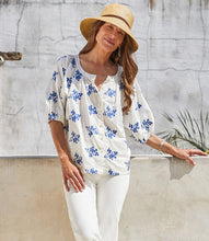 Load image into Gallery viewer, Lightweight cotton gives a breezy quality to this peasant top detailed with charming floral embroidery. It's finished with statement-making puff sleeves. Colors- Off white and blue. Short sleeve. Button down. Floral embroidery.