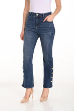 Load image into Gallery viewer, Woman wearing white top, blue ankle length jeans with button detailing and beige heels against a white background.