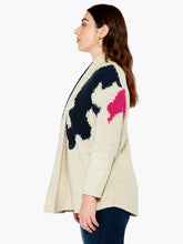 Load image into Gallery viewer, A super comfy classic shaker knit with a few modern touches. The details start at the yarn, where the dominant oatmeal color is accented by flecks of yellow and charcoal to add even more texture and interest. The intarsia knit blocks of black and pink do the rest. A slightly chunkier weight plus the shawl collar and extra length means it's perfect as an outer layer on crisper days. Color-Neutral Multi - oatmeal, (flecks of yellow and charcoal) black, pink. Intarsia knitting. Heavier weight.