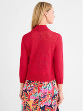 Load image into Gallery viewer, Woman wearing a red bolero cardigan over a colorful floral dress against a white background.