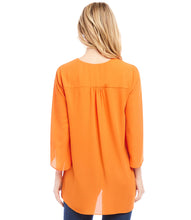 Load image into Gallery viewer, Floaty layers bring soft movement to a silky crepe blouse that can be worn for work or the weekend. The V-neck design adds a touch of femininity, while the 3/4 bracelet sleeves and eye-catching asymmetric crossover hem add a contemporary edge to a classic style.