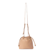 Load image into Gallery viewer, This stylish bucket bag is spacious, perfect for carrying all the essentials when you're on the go! It also features a removable and adjustable strap for easy carrying. Constructed from ultra-soft vegan leather, this bag is sure to have heads turning! Color- Latte. Removable strap. Interior slit pocket. Vegan leather. Drawstring closure.