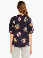 Load image into Gallery viewer, Sometimes it's all in the name! This dramatic combo of dark background and powerful pops of color on this stunning top is an outfit scene stealer, a real conversation piece. It's not just the firework display design though: we love the layered details on the short sleeves, the easy elastic cuffs, the frilled split neck, and the tie front. Dress it up with professional workpants or keep things casual with denim.