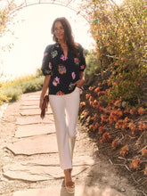 Load image into Gallery viewer, Sometimes it's all in the name! This dramatic combo of dark background and powerful pops of color on this stunning top is an outfit scene stealer, a real conversation piece. It's not just the firework display design though: we love the layered details on the short sleeves, the easy elastic cuffs, the frilled split neck, and the tie front. Dress it up with professional workpants or keep things casual with denim.