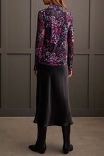 Load image into Gallery viewer, Our Blessyn Bright Violet Lined Turtleneck Top offers the perfect blend of comfort fused with contemporary style. Made from high quality, this turtleneck boasts a striking abstract design combining floral and animal prints, bringing a unique flair to your daily attire. Perfect for laid-back events or elegant affairs, this colorful top is sure to be a highlight in any trendsetting wardrobe.