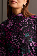 Load image into Gallery viewer, Our Blessyn Bright Violet Lined Turtleneck Top offers the perfect blend of comfort fused with contemporary style. Made from high quality, this turtleneck boasts a striking abstract design combining floral and animal prints, bringing a unique flair to your daily attire. Perfect for laid-back events or elegant affairs, this colorful top is sure to be a highlight in any trendsetting wardrobe.