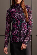 Load image into Gallery viewer, Our Blessyn Bright Violet Lined Turtleneck Top offers the perfect blend of comfort fused with contemporary style. Made from high quality, this turtleneck boasts a striking abstract design combining floral and animal prints, bringing a unique flair to your daily attire. Perfect for laid-back events or elegant affairs, this colorful top is sure to be a highlight in any trendsetting wardrobe.