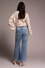 Load image into Gallery viewer, Woman wearing a sequined beige chetah print sweater, blue jeans with tiny rhinestones and beige heels against a plain background.