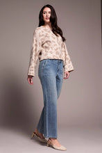 Load image into Gallery viewer, Woman wearing a sequined beige chetah print sweater, blue jeans with tiny rhinestones and beige heels against a plain background.