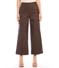 Load image into Gallery viewer, Introducing our contemporary and sustainable Cropped Vegan Leather Pants, tailored for fashion-conscious individuals who prioritize the environment. Constructed from premium materials, these pants offer the same modern look of leather while ensuring cruelty free. Color- Brown. Wide-leg. Elasticized waistband. Invisible side zipper. Fabric - 50% Viscose 50% Polyurethane.