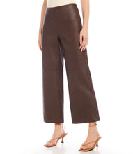 Load image into Gallery viewer, Introducing our contemporary and sustainable Cropped Vegan Leather Pants, tailored for fashion-conscious individuals who prioritize the environment. Constructed from premium materials, these pants offer the same modern look of leather while ensuring cruelty free. Color- Brown. Wide-leg. Elasticized waistband. Invisible side zipper. Fabric - 50% Viscose 50% Polyurethane.