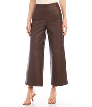Load image into Gallery viewer, Introducing our contemporary and sustainable Cropped Vegan Leather Pants, tailored for fashion-conscious individuals who prioritize the environment. Constructed from premium materials, these pants offer the same modern look of leather while ensuring cruelty free. Color- Brown. Wide-leg. Elasticized waistband. Invisible side zipper. Fabric - 50% Viscose 50% Polyurethane.