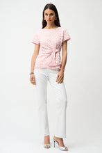 Load image into Gallery viewer, Woman wearing a short sleeve pink textured top, white pants and silver heels on a white background.