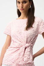 Load image into Gallery viewer, Woman wearing a short sleeve pink textured top and silver earrings on a white background.