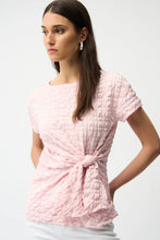 Load image into Gallery viewer, Woman wearing a short sleeve pink textured top and silver earrings on a white background.