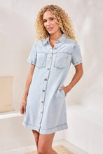 Load image into Gallery viewer, Woman wearing a light blue denim dress in a neutral setting.