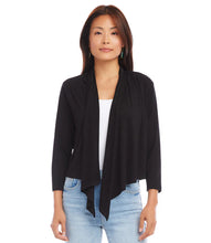 Load image into Gallery viewer, Woman wearing a black cardigan over a white top and blue jeans on a white background.