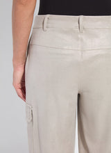Load image into Gallery viewer, Close-up of the back of soft taupe shiny cargo pants and black top worn by a model against a white background.