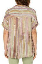 Load image into Gallery viewer, Make a statement in this watercolor printed woven top featuring a hi-low hem! Pastel hues of pinks and greens make this top the perfect addition to your wardrobe. Pairs beautifully with denim or dress it up with a trouser! Looks fabulous paired with our Spanish Moss Liverpool LA jacket. Colors- Watercolor Stripe Print - Pinks, greens, lilac, tan. Short sleeve. Inverted placket. Collared. Button front. Hi-low hem.