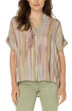 Load image into Gallery viewer, Make a statement in this watercolor printed woven top featuring a hi-low hem! Pastel hues of pinks and greens make this top the perfect addition to your wardrobe. Pairs beautifully with denim or dress it up with a trouser! Looks fabulous paired with our Spanish Moss Liverpool LA jacket. Colors- Watercolor Stripe Print - Pinks, greens, lilac, tan. Short sleeve. Inverted placket. Collared. Button front. Hi-low hem.