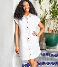 Load image into Gallery viewer, Elevate your wardrobe with the effortlessly chic Celina Cap Sleeve Denim Dress by Karen Kane. Crafted from durable cotton twill denim, this stylish shirtdress features metallic snap closures, cap sleeves, and a flattering relaxed fit—perfect for spring and summer. Designed for versatility, it pairs beautifully with sneakers, sandals, or heels, making it an ideal choice for casual outings or dressed-up occasions.