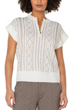 Load image into Gallery viewer, Model wearing a cap sleeve cream half zipper sweater with camel stitching throughout and brown check pants against a white background.