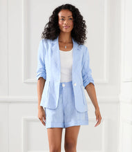 Load image into Gallery viewer, Stay cool and stylish with the Karen Kane Caroline Capri Blue Pleated Shorts, crafted from breathable yarn-dyed linen. Featuring stylized pleats, convenient side pockets, and a chic cuffed hem, these high-waisted shorts offer a polished yet casual look. Perfect for warm days, they pair effortlessly with your favorite tops for versatile styling.