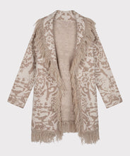 Load image into Gallery viewer, This animal print cardigan with fringe detailing is classic and stylish. The cardigan features a belted waist that adds visual interest. Whether you dress it up or pair it with denim, it's the ideal accessory for cooler weather where a jacket or coat might be too heavy. Color-Bisquit; Light tan and white. Animal print. Belted closure. Fringe detailing all around. Longer design. Fabric - 85% Acrylic. 15% Polyester.
