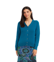 Load image into Gallery viewer, Woman wearing a teal cardigan and colorful skirt against a white background.