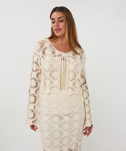 Load image into Gallery viewer, Woman wearing a natural color crochet cardigan and matching skirt against a white background.