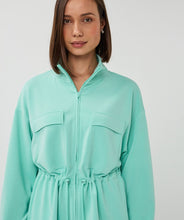 Load image into Gallery viewer, Woman wearing a mint green cardigan against a plain background.