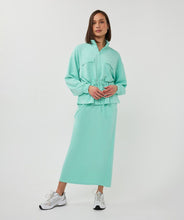 Load image into Gallery viewer, Person wearing a mint green cardigan with a matching skirt and tennis shoes against a white background.