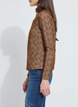 Load image into Gallery viewer, Woman wearing a brown textured long sleeve turtleneck and blue jeans with fringe trim against a white background.