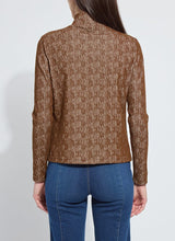 Load image into Gallery viewer, Woman wearing a brown textured long sleeve turtleneck and blue jeans with fringe trim against a white background.