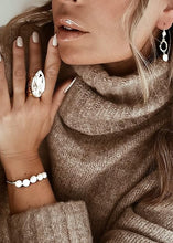 Load image into Gallery viewer, Perfect for any wrist, this timeless bracelet showcases an adjustable design embellished with freshwater pearls. A versatile piece suitable for any occasion.