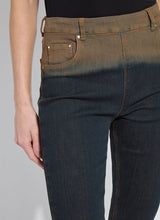 Load image into Gallery viewer, Close-up of a person wearing dark blue jeans with a gradient effect against a gray background.